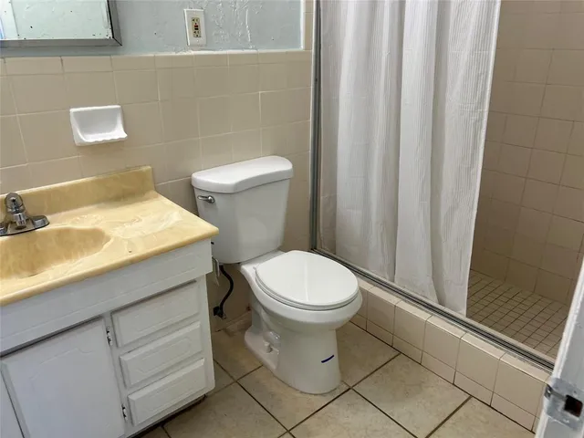a white toilet sitting next to a bathroom sink