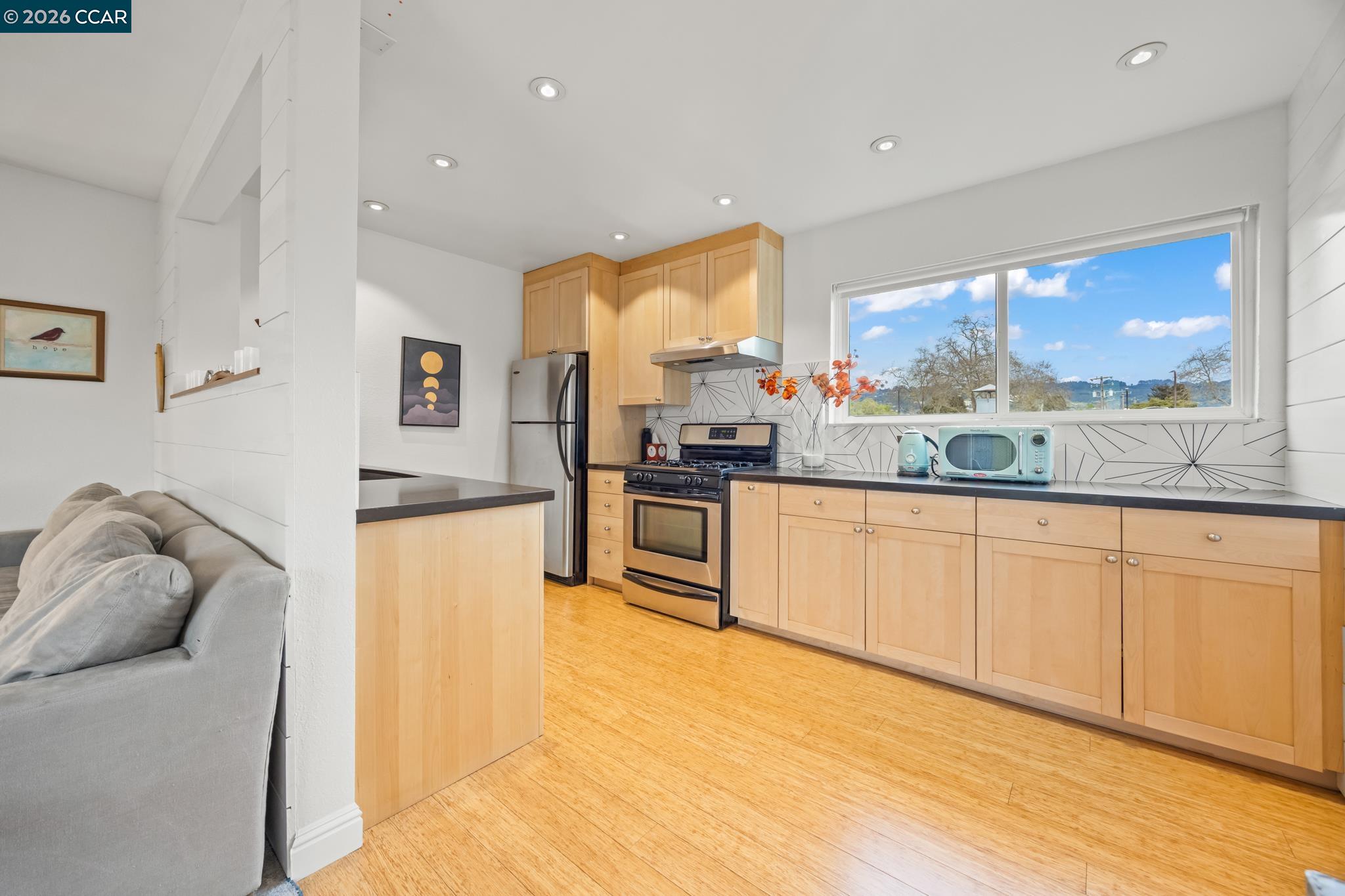 2327 Tenth Street, Unit 4 Berkeley, CA 94710 - Photo 9 of 39 a kitchen with stainless steel appliances granite countertop a stove a sink and a refrigerator