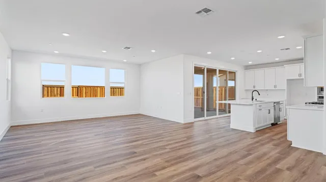 a view of kitchen with wooden floor and electronic appliances