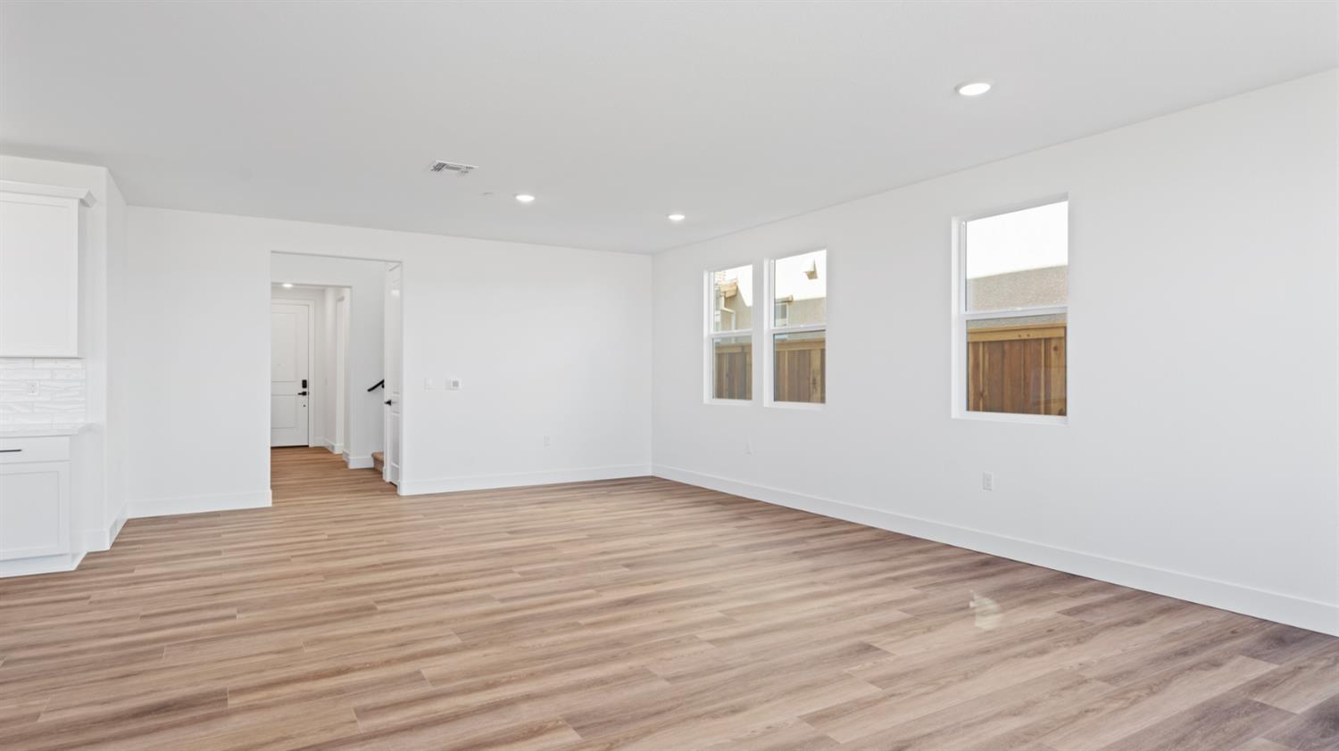 775 Lorca Street Mountain House, CA 95391 - Photo 14 of 41 a view of an empty room with wooden floor and windows