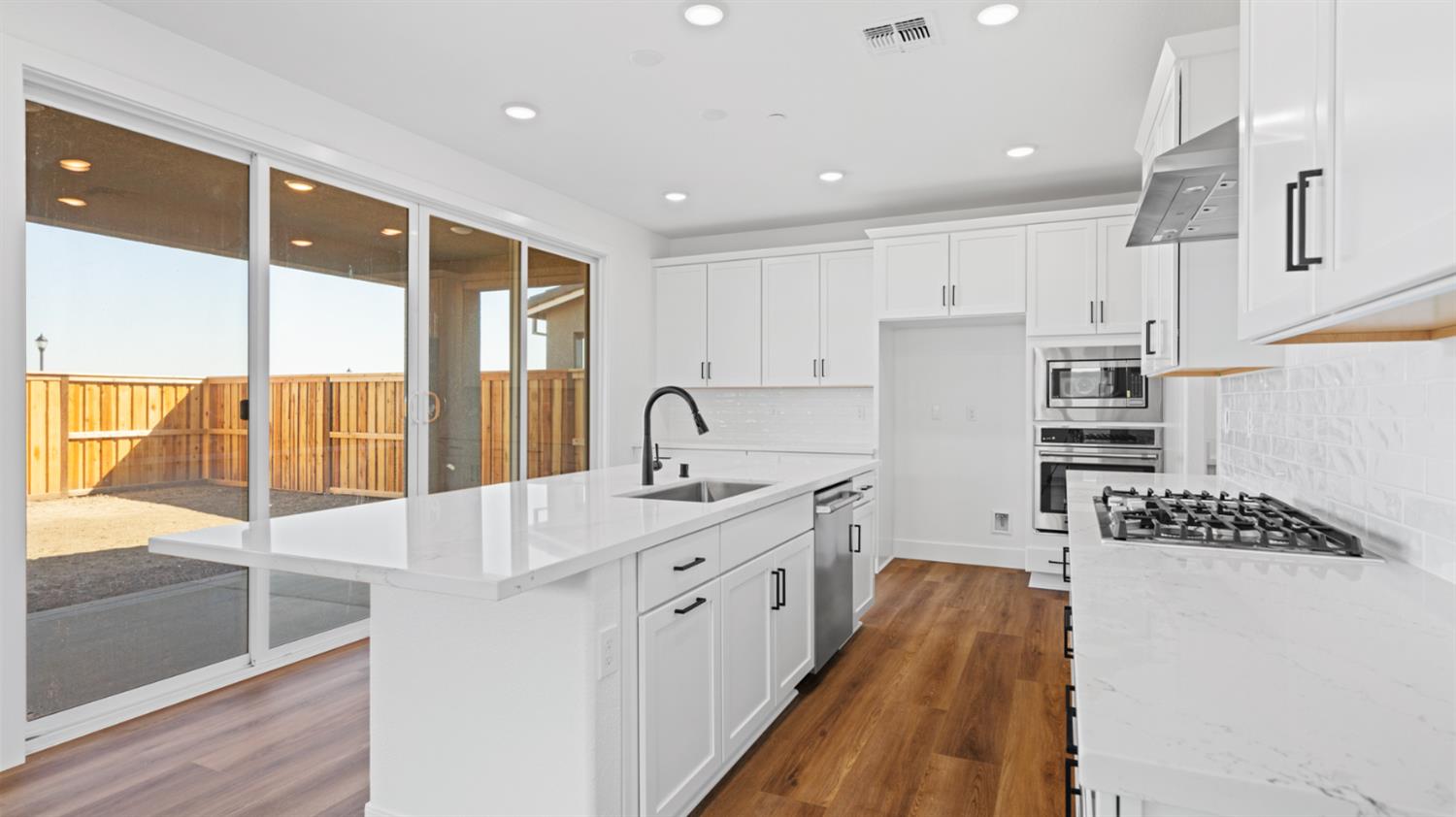 775 Lorca Street Mountain House, CA 95391 - Photo 16 of 41 a kitchen with stainless steel appliances granite countertop a sink stove and refrigerator