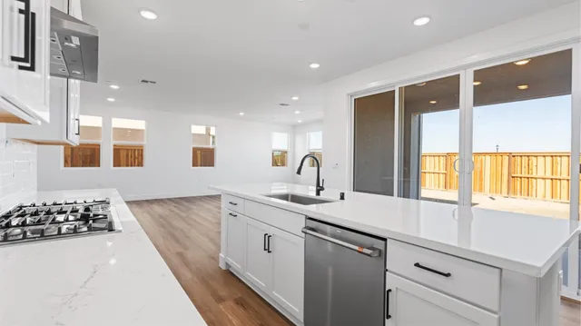 a kitchen with a sink stove and refrigerator