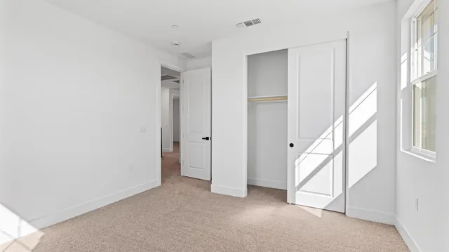 a view of cabinets a sink and dishwasher with wooden floor