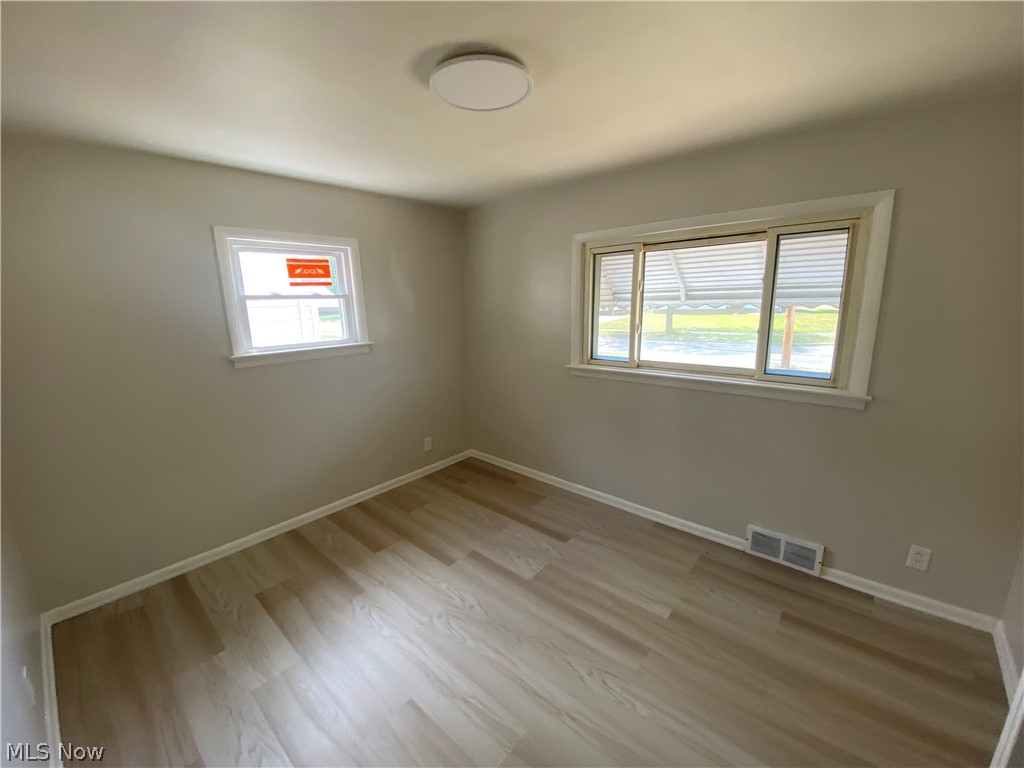 13117 Silver Road Garfield Heights, OH 44125 - Photo 11 of 20 Unfurnished room with plenty of natural light and hardwood / wood-style flooring