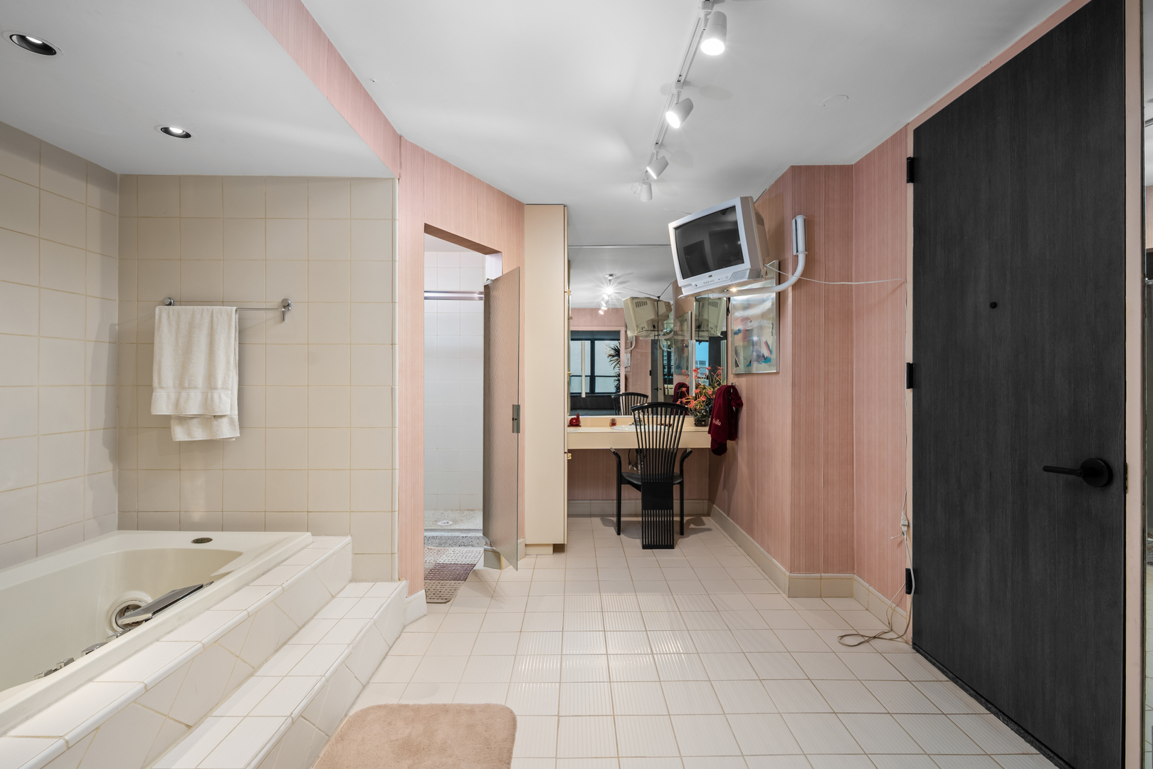 1030 North State Street, Unit 51EF Chicago, IL 60610 - Photo 15 of 20 a bathroom with a bathtub shower sink and white appliances