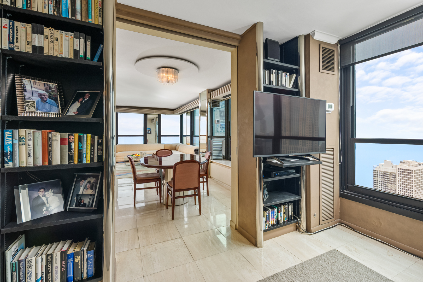 1030 North State Street, Unit 51EF Chicago, IL 60610 - Photo 5 of 20 a view of living room filled with furniture and a book shelf