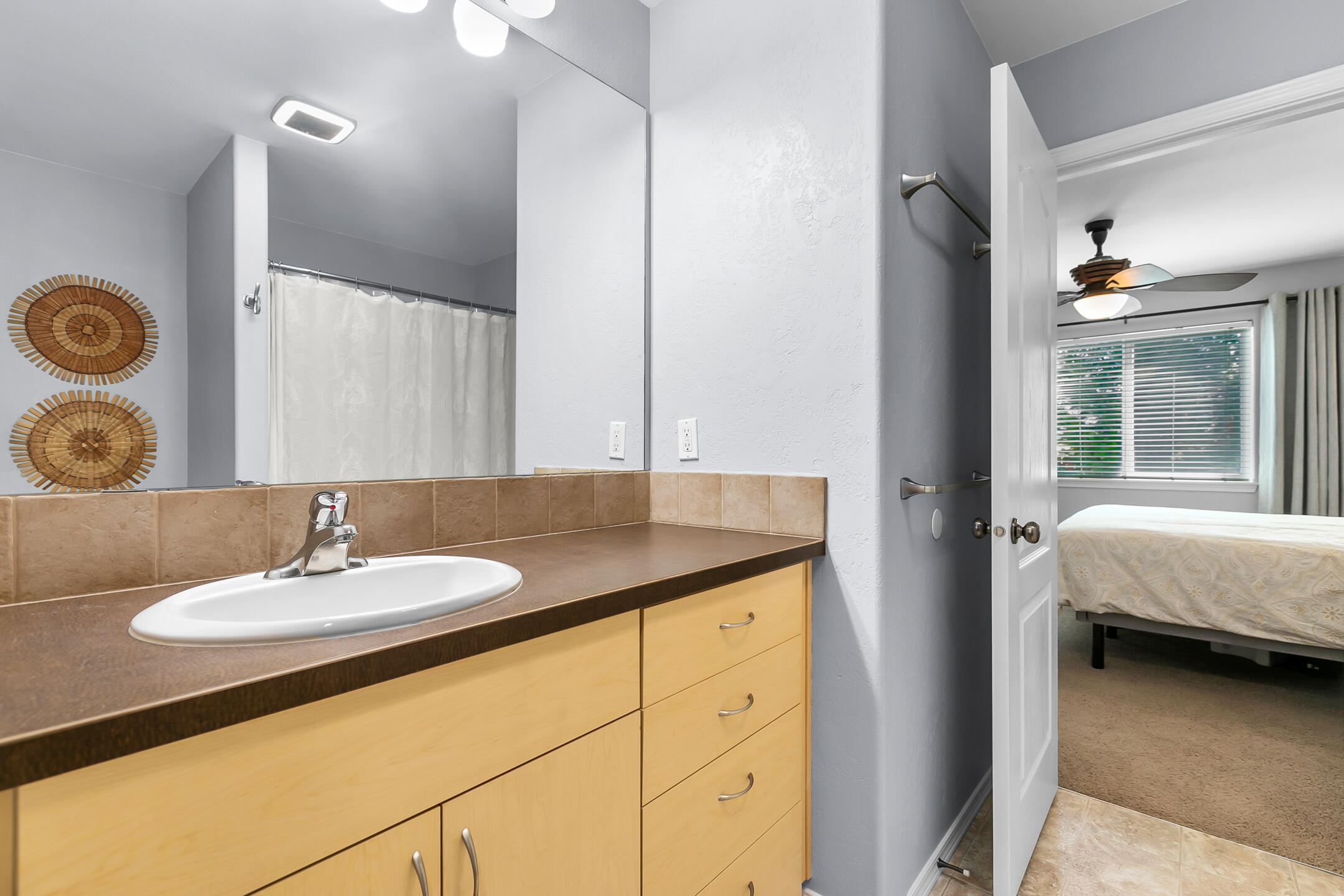 21363 Pecoraro Loop Bend, OR 97701 - Photo 12 of 15 a en suite bathroom with a granite countertop sink and a mirror