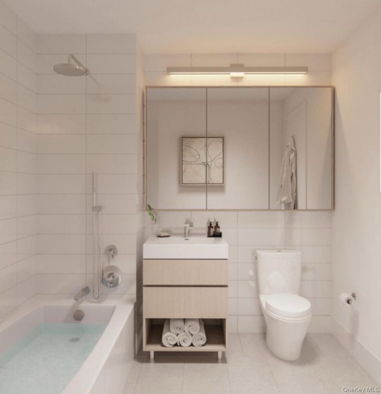 131-02 40th Road, Unit 10F Queens, NY 11354 - Photo 11 of 15 a bathroom with a sink a toilet and bathtub