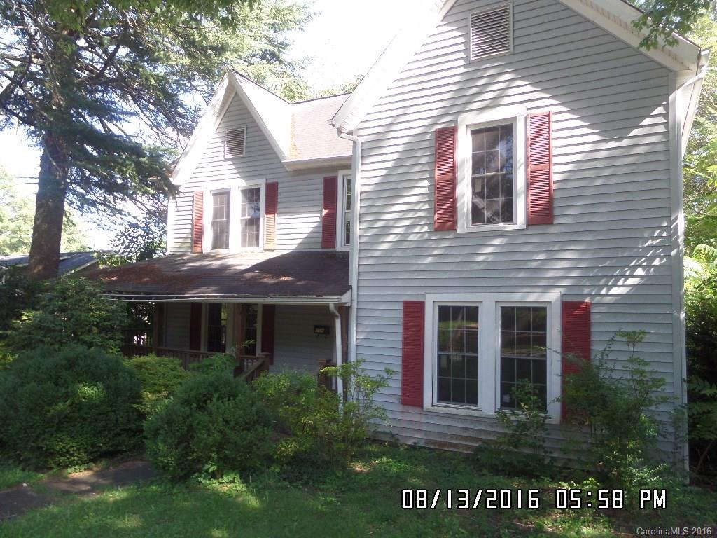159 Pine Street Rutherfordton, NC 28139 - Photo 2 of 23 a view of a brick house with a large windows and flower plants