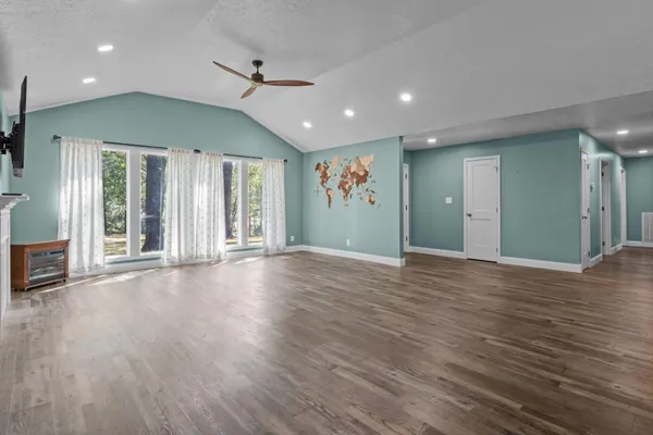 a view of a room with furniture and wooden floor