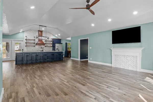 a kitchen with a sink a refrigerator and wooden cabinets