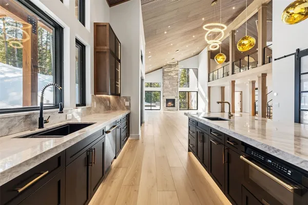 a large kitchen with stainless steel appliances granite countertop a lot of counter space and a sink