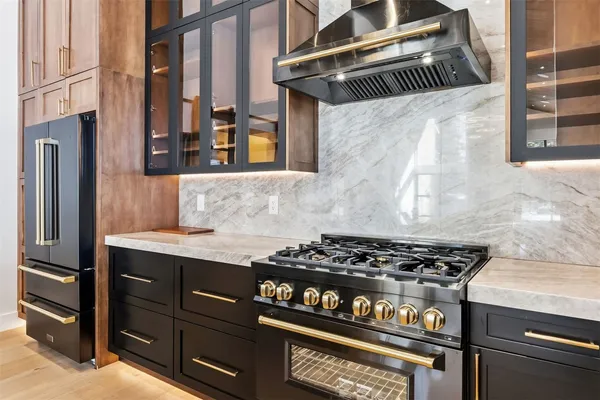 a kitchen with granite countertop a stove and a sink
