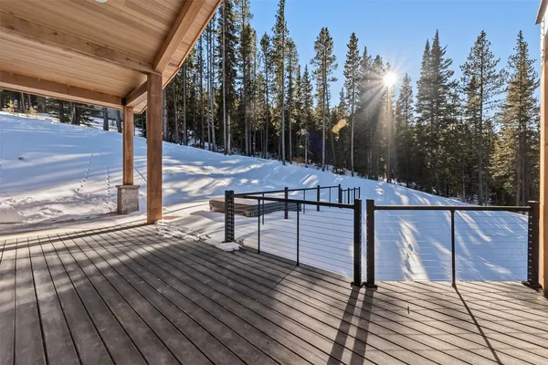 a view of a roof deck with wooden floor and fence with a wooden fence