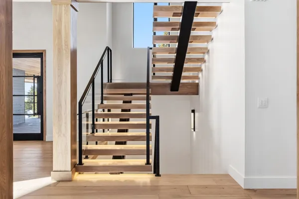 a view of entryway with wooden floor and windows