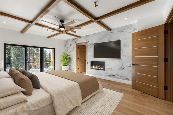a spacious bedroom with a bed and a flat screen tv
