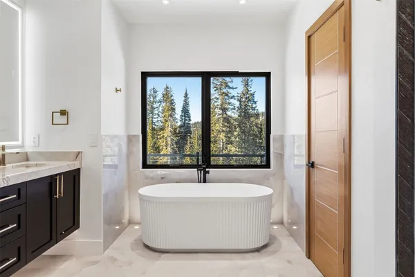 a bathroom with a bathtub and a sink
