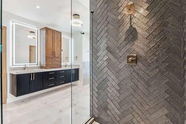 a bathroom with a double vanity sink a mirror and shower