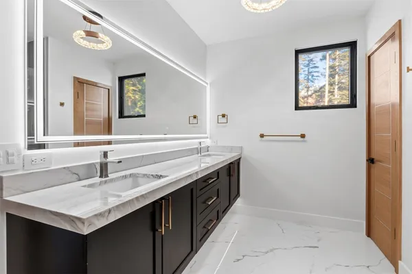 a bathroom with a sink and a mirror