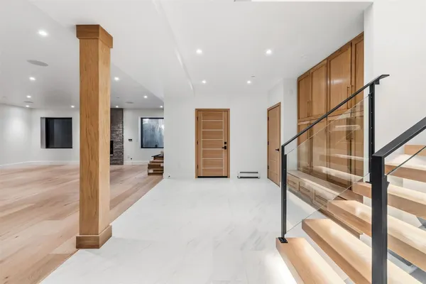 a view of a hallway with wooden floor and entryway