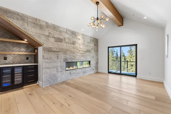 a view of an empty room with a fireplace and a window