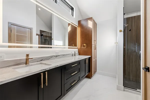 a bathroom with a granite countertop sink and a mirror