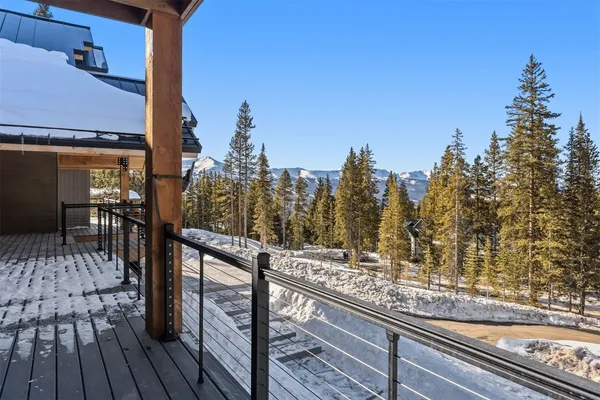 a view of a balcony with wooden floor and bench