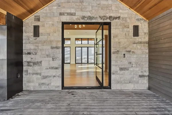 a view of outdoor space with wooden floor and a window