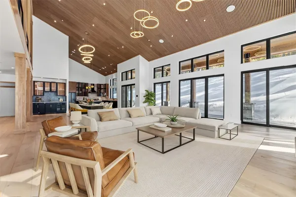 a living room with furniture and large windows