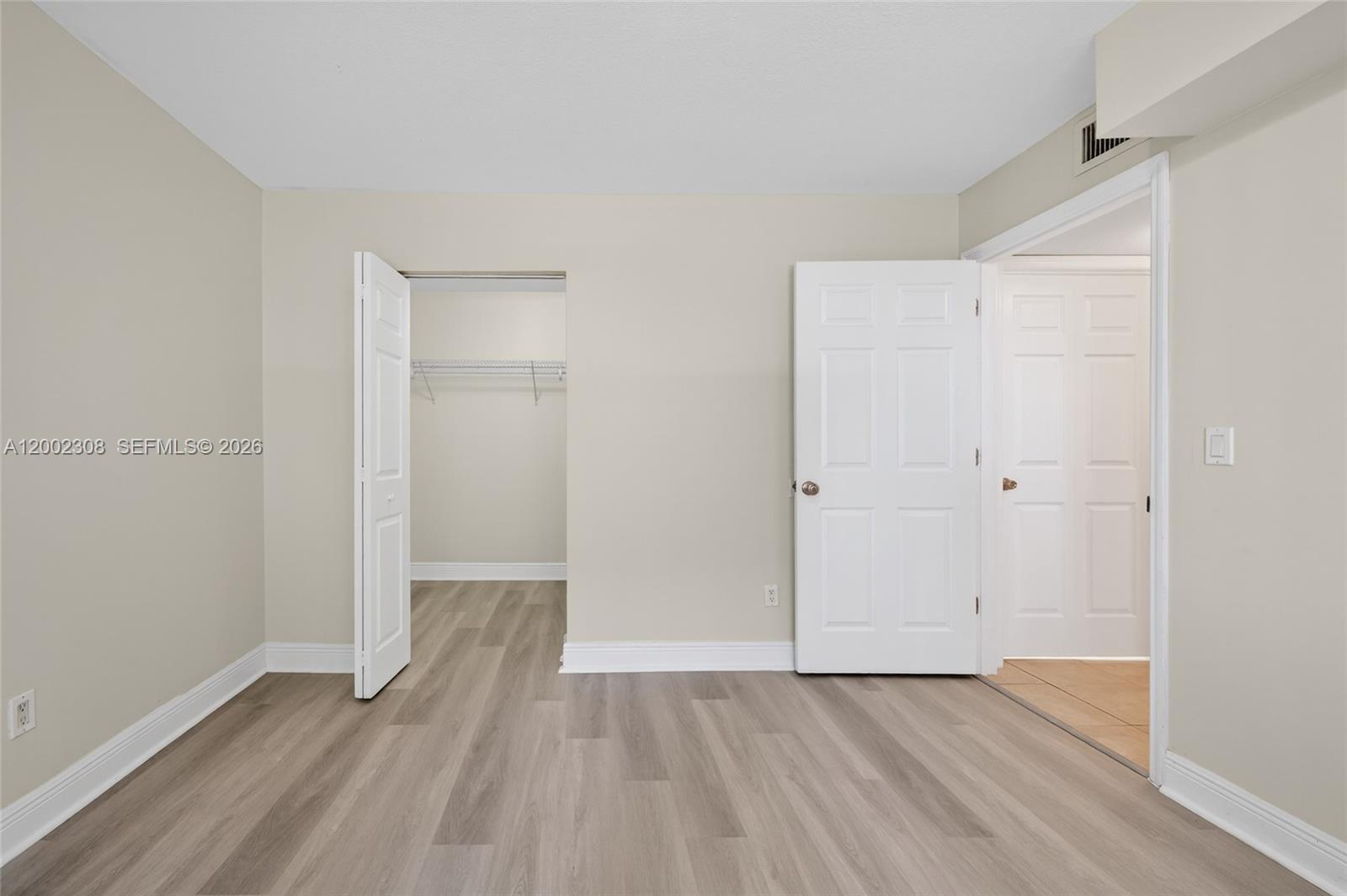 4025 West McNab Road, Unit E109 Pompano Beach, FL 33069 - Photo 13 of 27 an empty room with wooden floor