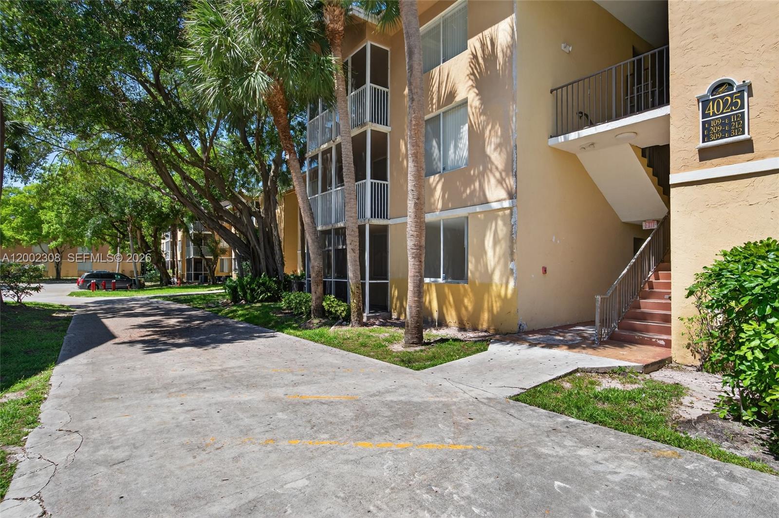 4025 West McNab Road, Unit E109 Pompano Beach, FL 33069 - Photo 19 of 27 a view of a building with a yard