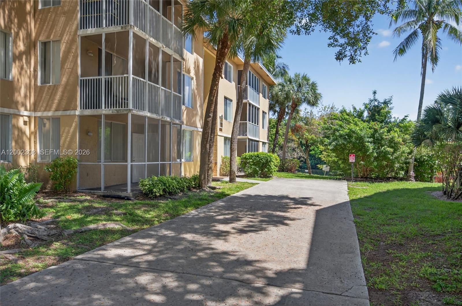 4025 West McNab Road, Unit E109 Pompano Beach, FL 33069 - Photo 20 of 27 a view of a building with a yard
