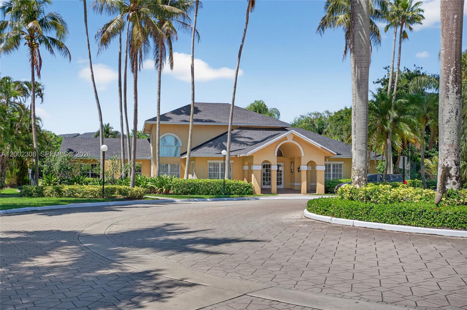 4025 West McNab Road, Unit E109 Pompano Beach, FL 33069 - Photo 23 of 27 a front view of house with a garden