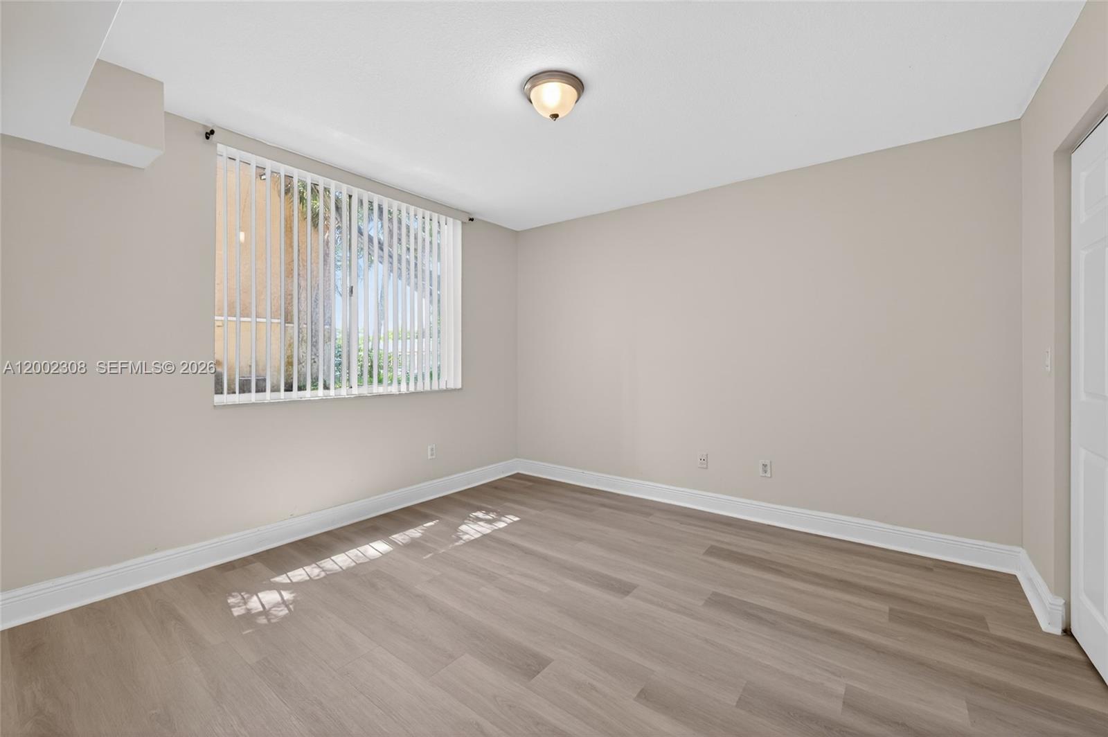 4025 West McNab Road, Unit E109 Pompano Beach, FL 33069 - Photo 10 of 27 a view of a room that has wooden floor and windows in it