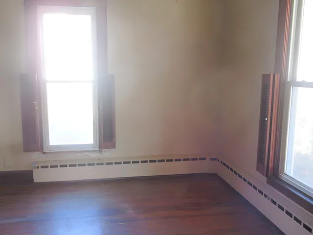a view of empty room with a fireplace