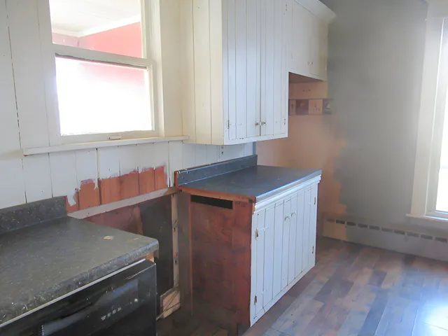 a kitchen with a sink cabinets and window