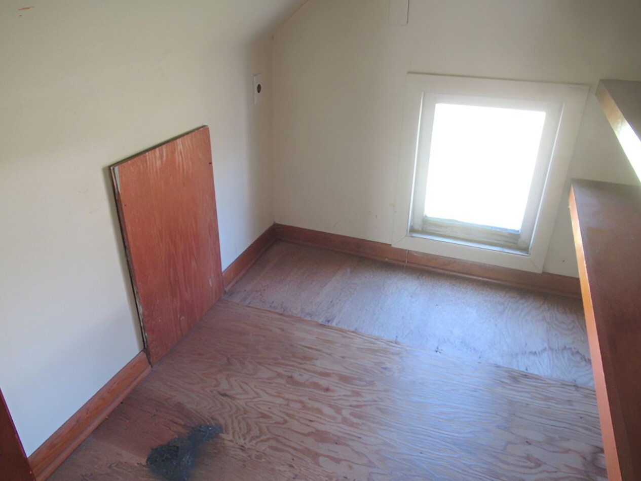 504 South Seminary Street Georgetown, IL 61846 - Photo 9 of 28 an empty room with wooden floor and windows