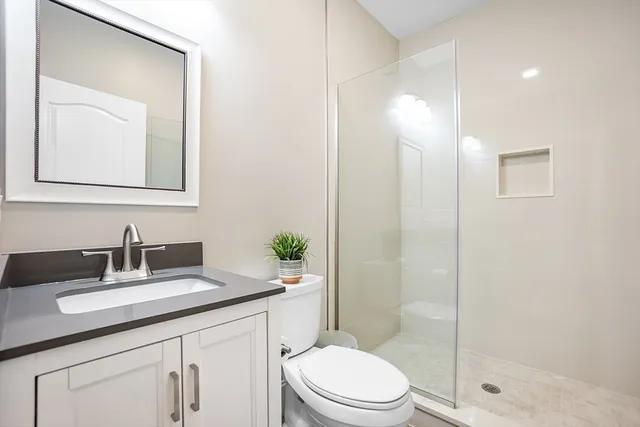 a kitchen with stainless steel appliances kitchen island granite countertop a dining table chairs and view living room