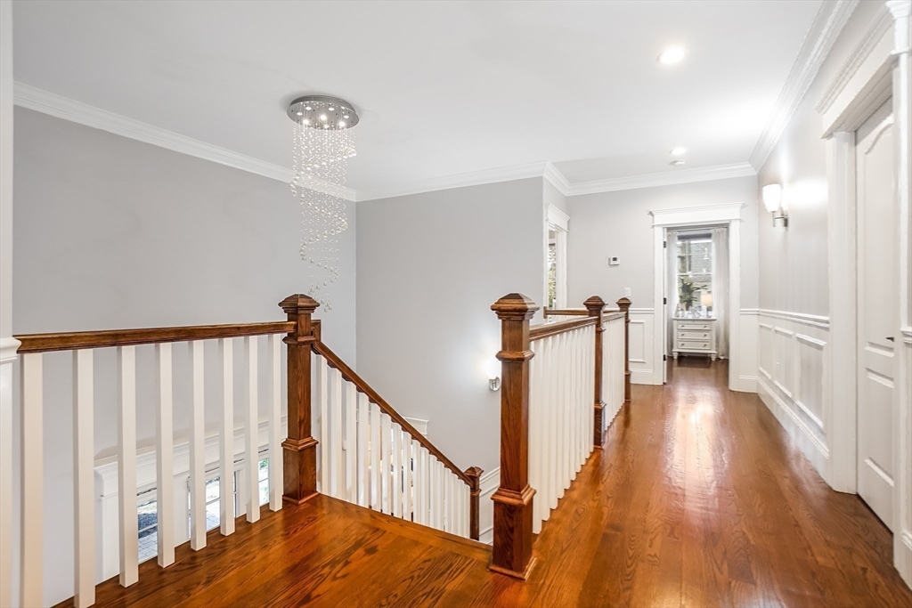 57 Walnut Street Newton, MA 02460 - Photo 20 of 42 a view of a hallway with wooden floor and stairs