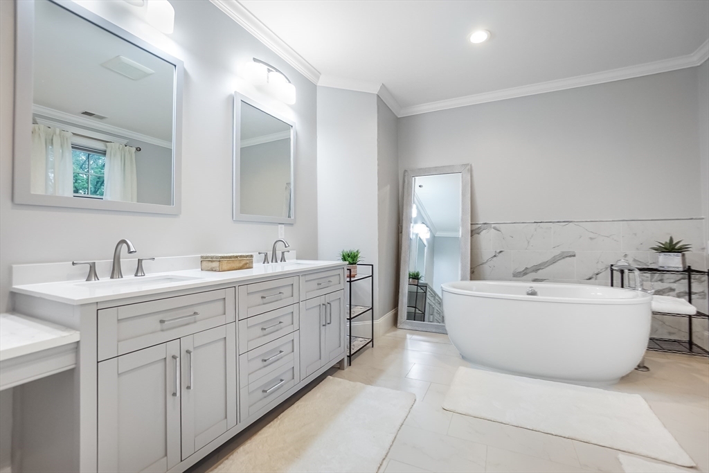 57 Walnut Street Newton, MA 02460 - Photo 23 of 42 a bathroom with a tub sink and mirror