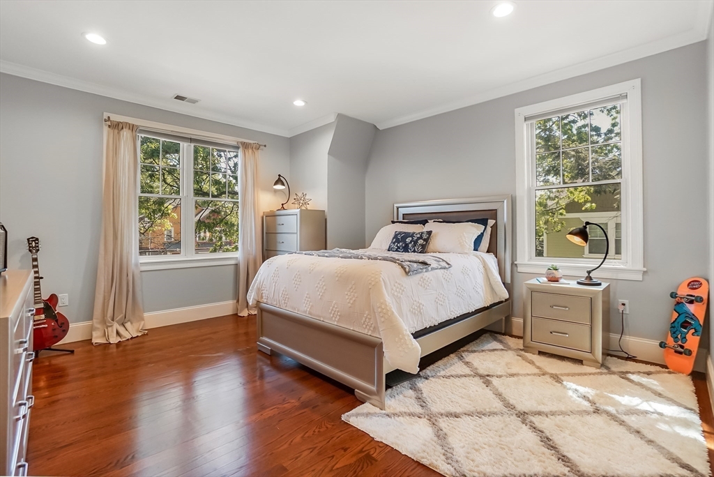 57 Walnut Street Newton, MA 02460 - Photo 25 of 42 a bed sitting in a bedroom next to a window