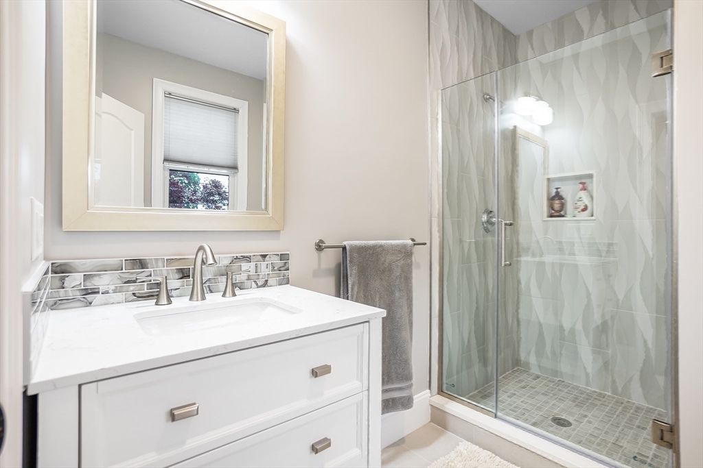 57 Walnut Street Newton, MA 02460 - Photo 26 of 42 a bathroom with a sink vanity and a mirror