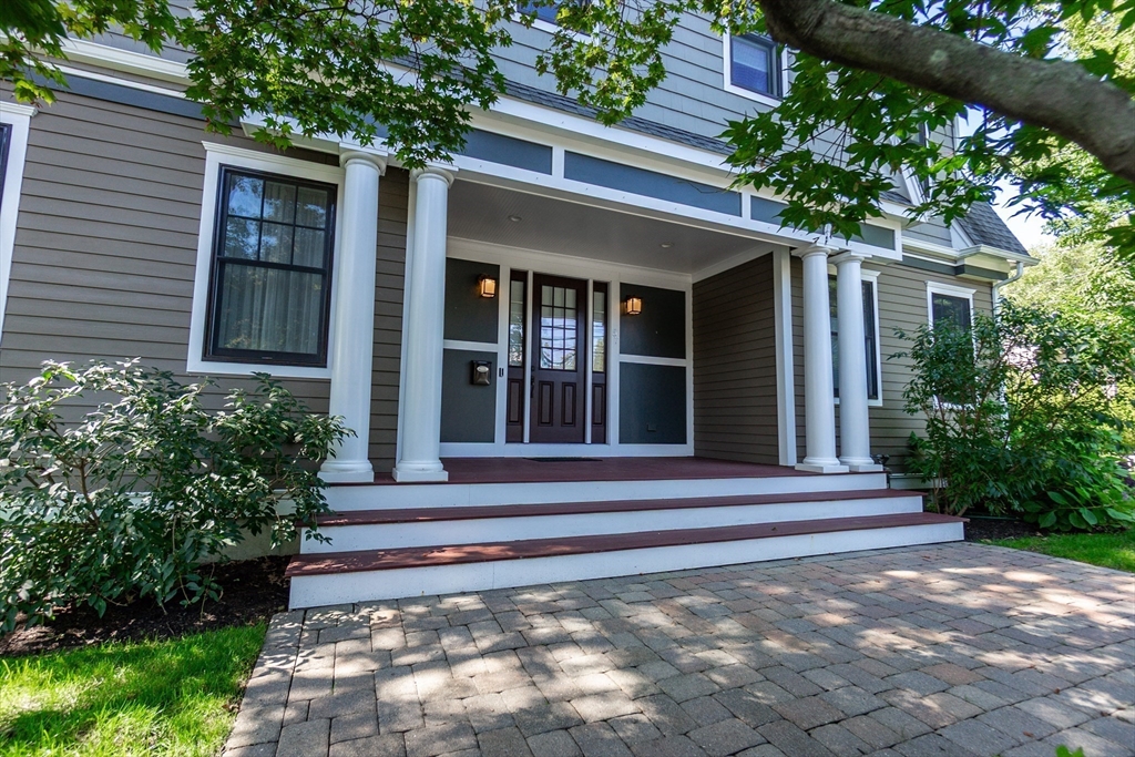 57 Walnut Street Newton, MA 02460 - Photo 4 of 42 a view of a house with potted plants and a large tree