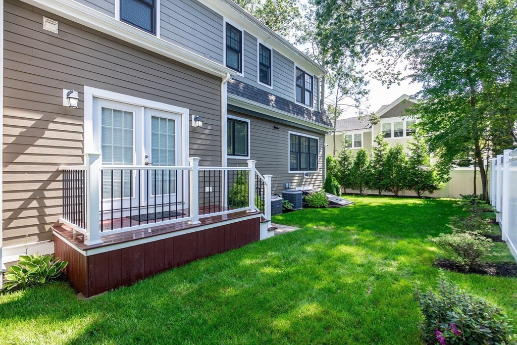 57 Walnut Street Newton, MA 02460 - Photo 9 of 42 a view of a house with a backyard and a garden