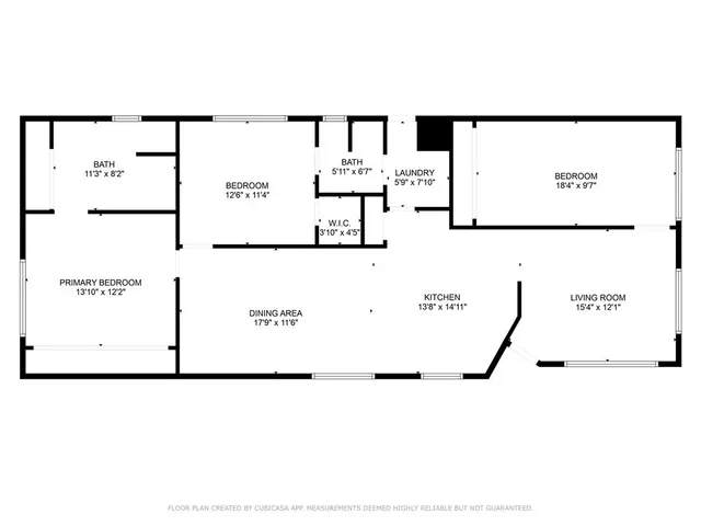 a view of a house with a yard potted plants and a bench