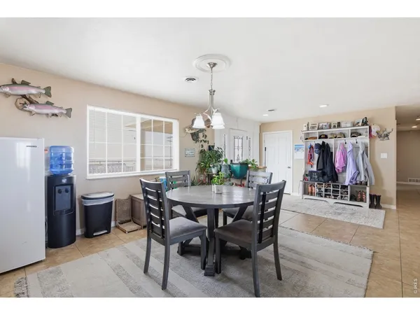 a view of a dining room with furniture and window