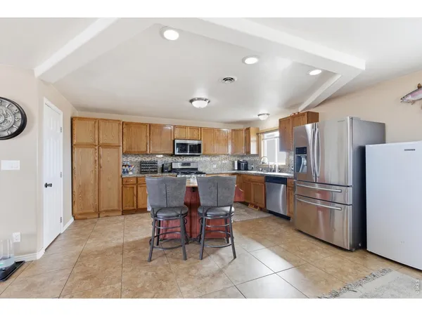 a kitchen with refrigerator cabinets and furniture