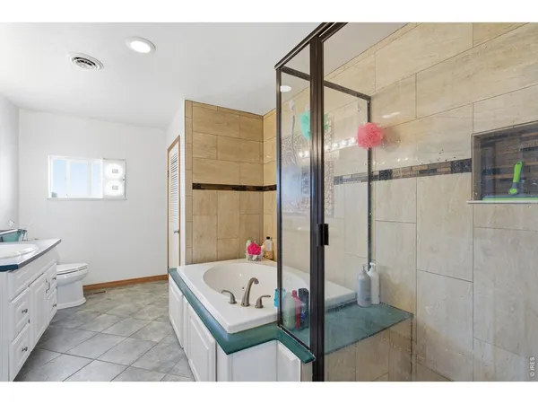 a bathroom with a tub sink shower and mirror