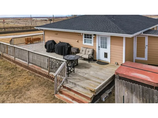 a terrace of a house with wooden floor outdoor seating