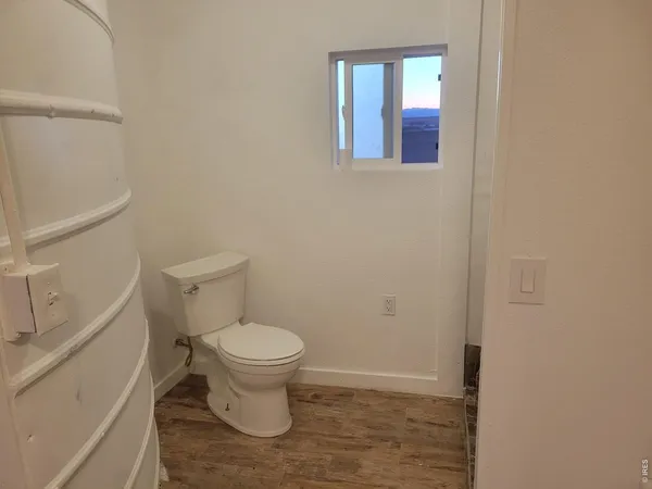 a white toilet sitting in a bathroom next to a sink